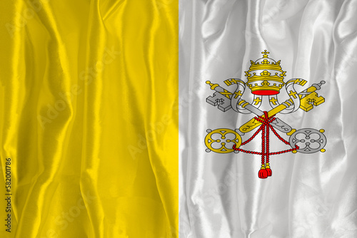 The flag of the Vatican on a silk background is a great national symbol. Texture of fabrics The official state symbol of the country
