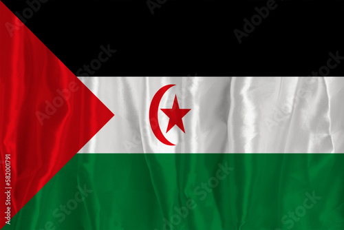 The flag of Western Sahara on a silk background is a great national symbol. Texture of fabrics The official state symbol of the country