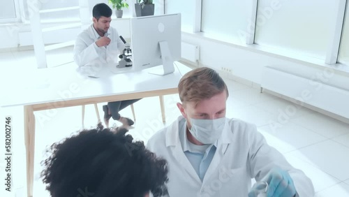 scientists examining control samples in the laboratory .