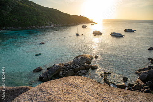 Beautiful scenery of Donald Duck Bay or Ao Kuerk Bay during sunset with tourist boat, view from Sailboat rock viewpoint at Similan island number 8, Similan National Park, Phang-nga Province, Thailand. photo