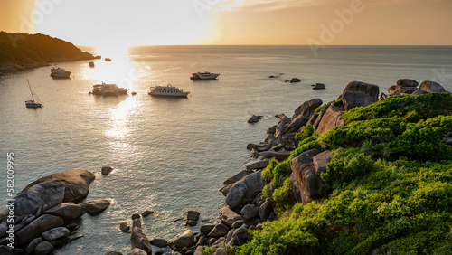 Beautiful scenery of Donald Duck Bay or Ao Kuerk Bay during sunset with tourist boat, view from Sailboat rock viewpoint at Similan island number 8, Similan National Park, Phang-nga Province, Thailand.