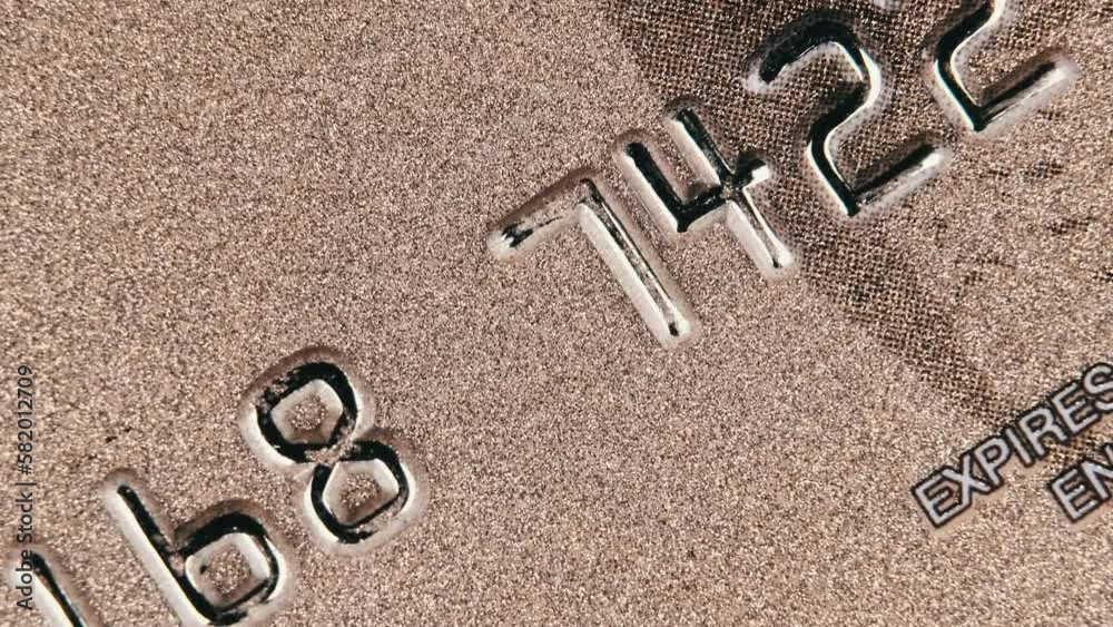 The credit card rotates close up. Plastic bank card spinning in macro