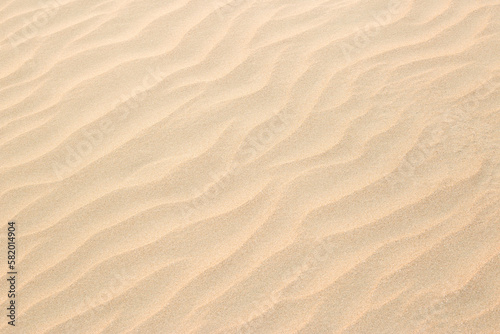 Abstract background of sandy sea on the beach. Wave sand texture