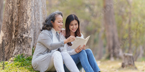 Adult daughter and her elderly mother have outdoor activity together