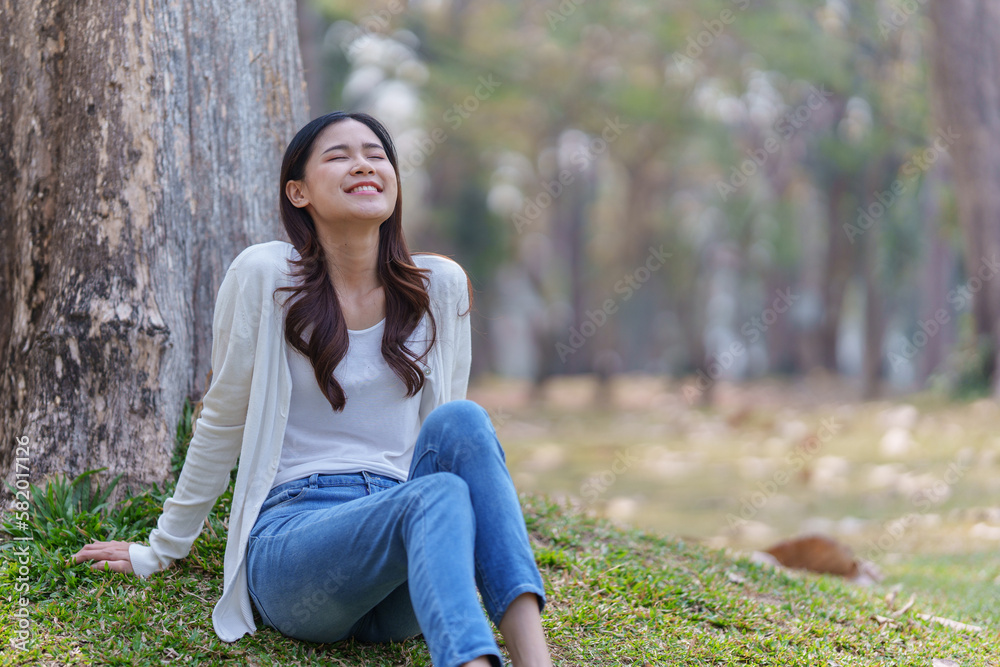 Cheerful overjoyed woman happy and enjoying peaceful beautiful in park, looking up with broad smile Cheerful overjoyed woman happy and enjoying peaceful beautiful in park, looking up with broad smile