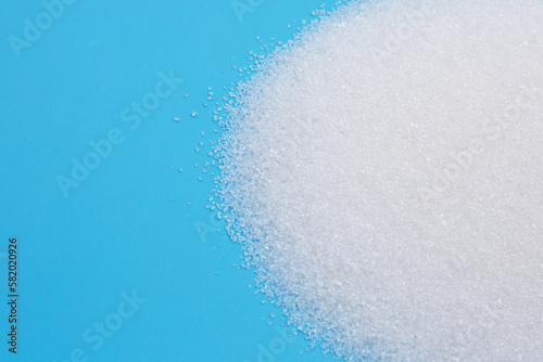 White sugar on blue background.