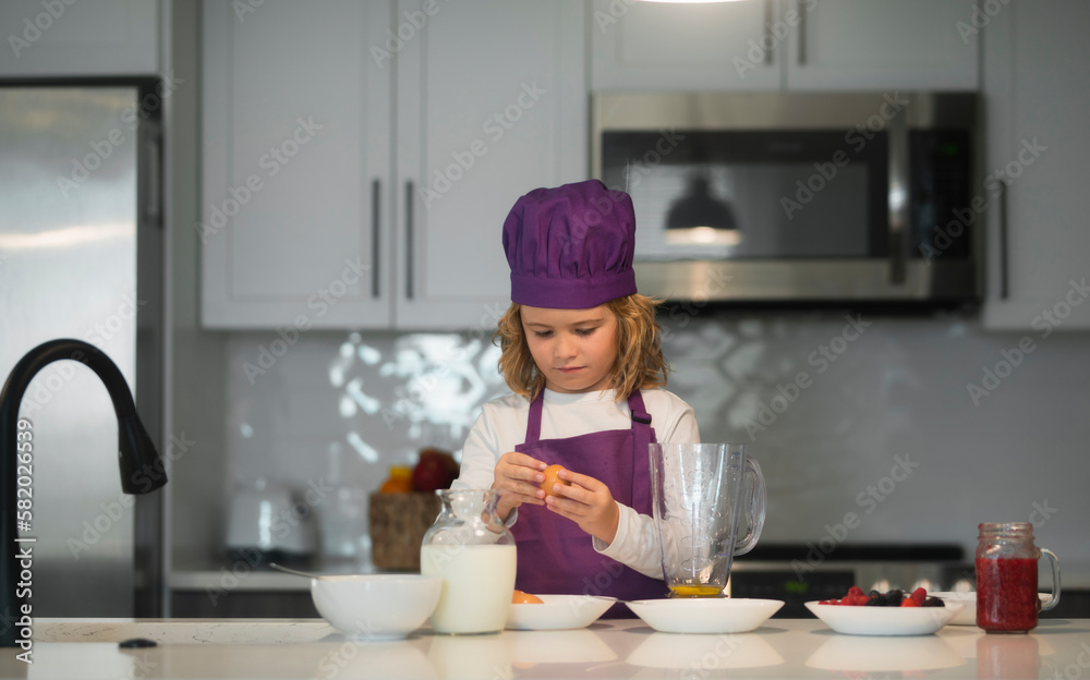 Cooking in kitchen. Child wearing cooker uniform preparing healthy food. Healthy ingredients. Cooking in kitchen. Child wearing cooker uniform preparing healthy food. Healthy ingredients.