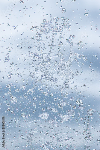 splashes of water under pressure on a light background © studybos
