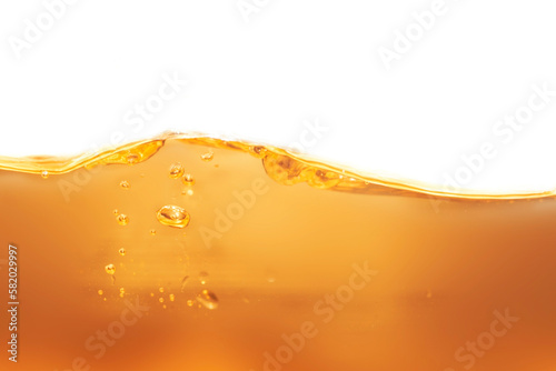 Appearance surface poured brownish yellow lubricant liquid for bubbles background can use cooking oil.	
