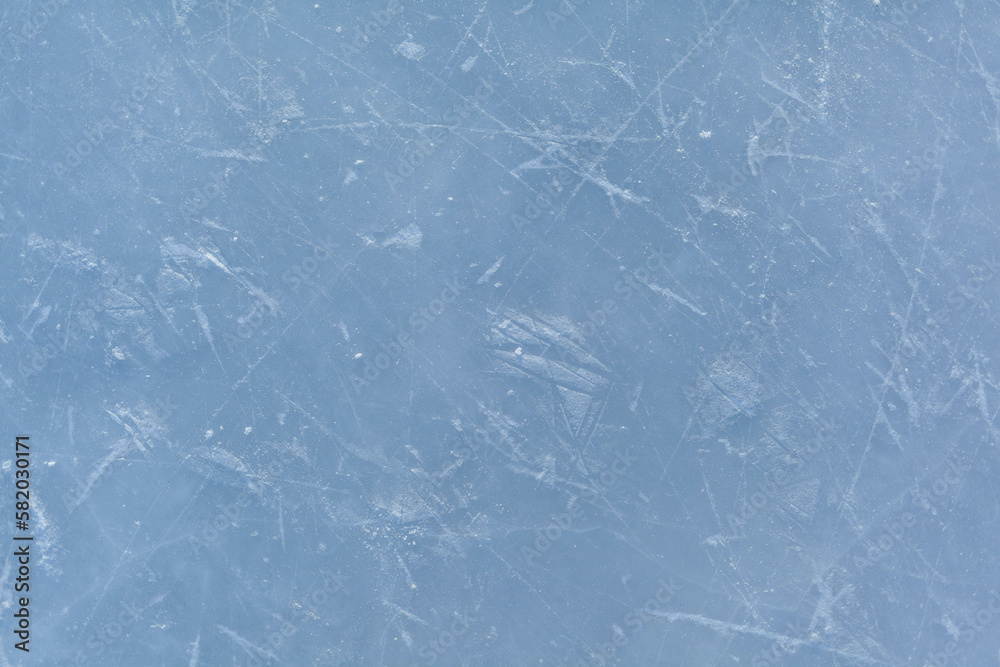Empty ice rink with skate marks after the session outdoor. skating ice rink texture covered with snow in daylight. Close up of blue ice rink floor, copy space Empty ice rink with skate marks after the session outdoor. skating ice rink texture covered with snow in daylight. Close up of blue ice rink floor, copy space