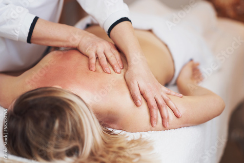 Woman having back body massage in studio