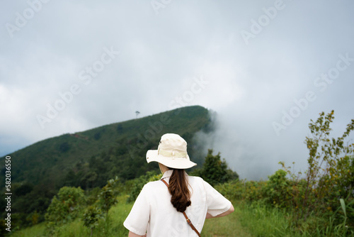 Women with hat is looking next mountain
