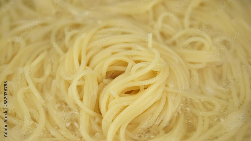 Cooking spaghetti in boiling water, slider shot. Boiling pasta in pot, close up Cooking spaghetti in boiling water, slider shot. Boiling pasta in pot, close up