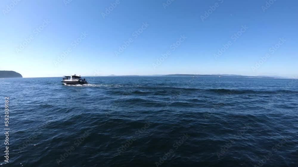 The blue sea of ​​the Pacific Ocean. Nearby is a boat sailing. Blue sea of Northwest.