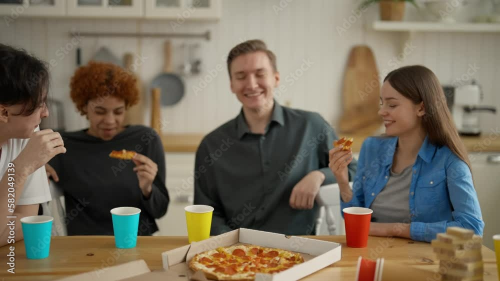 Meeting group friends, happy multiracial young people laughing, eating pizza in home. Cheerful students or colleagues having fun enjoying talking,eat lunch food, drink. Together spend time at leisure. Meeting group friends, happy multiracial young people laughing, eating pizza in home. Cheerful students or colleagues having fun enjoying talking,eat lunch food, drink. Together spend time at leisure.