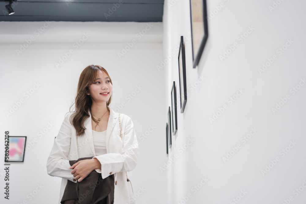 Woman visiting art gallery her looking pictures on wall watching photo frame painting at artwork museum people lifestyle concept. Woman visiting art gallery her looking pictures on wall watching photo frame painting at artwork museum people lifestyle concept.