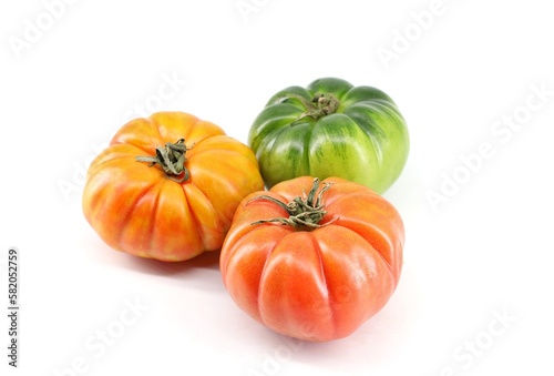 Ribbed Italian tomatoes Costoluto on white background in  three different ripening state. photo