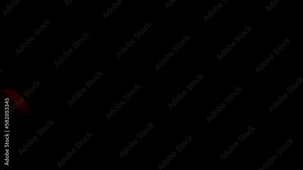 Glowing particles in motion on black background Glowing particles in motion on black background