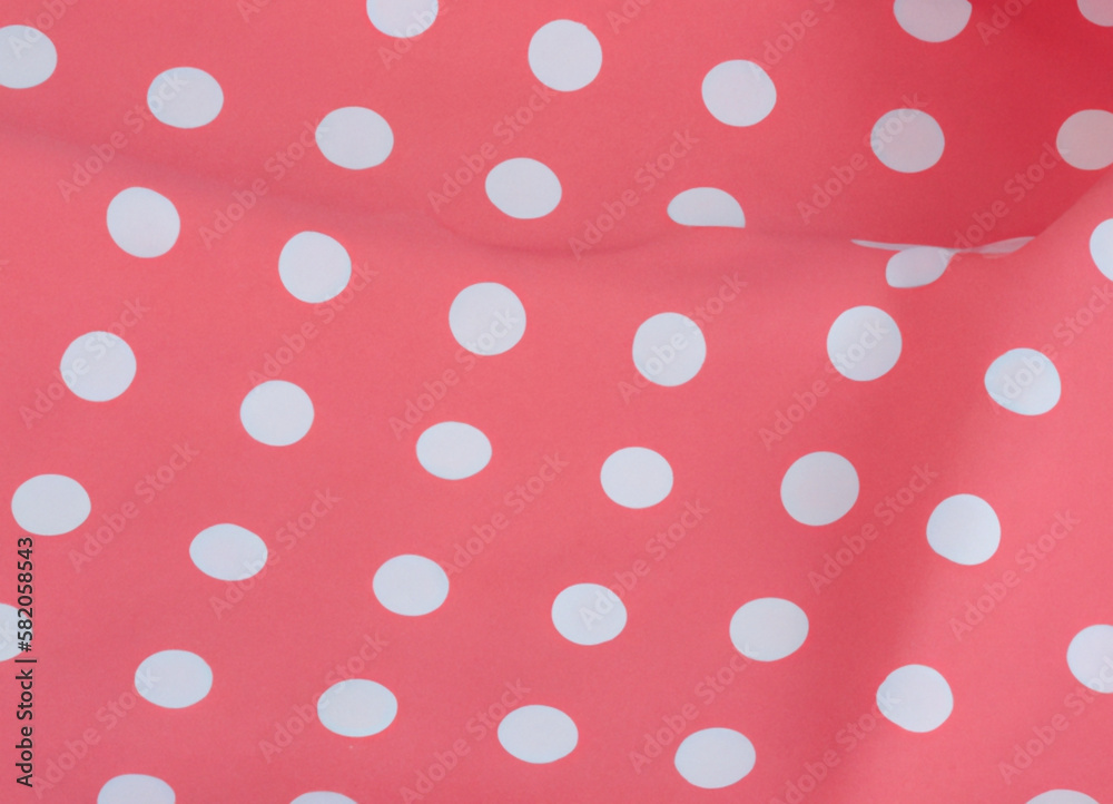 White polka dots on red pink background, textile fabric surface background.