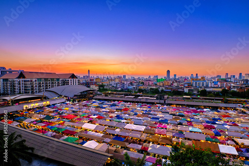 Beautiful sunset over Bangkok  Thailand  and colorful night market. 