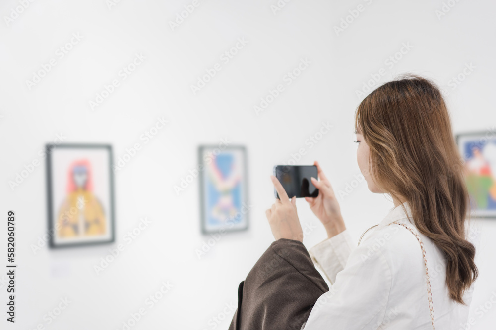 Woman visiting art gallery her looking pictures on wall watching photo frame painting at artwork museum people lifestyle concept. Woman visiting art gallery her looking pictures on wall watching photo frame painting at artwork museum people lifestyle concept.