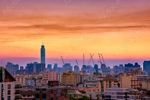 Colorful sunset over big city, downtown skyline and residential area. 