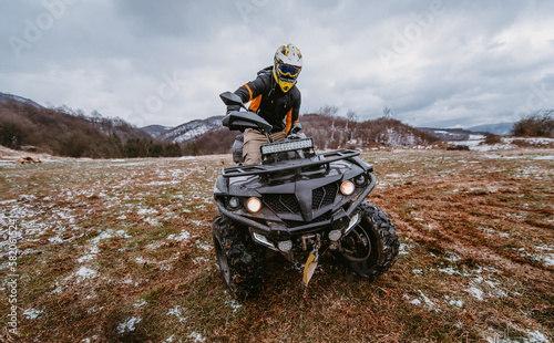 A man drives an ATV in the mud. Drift driving an ATV quad in mud and snow