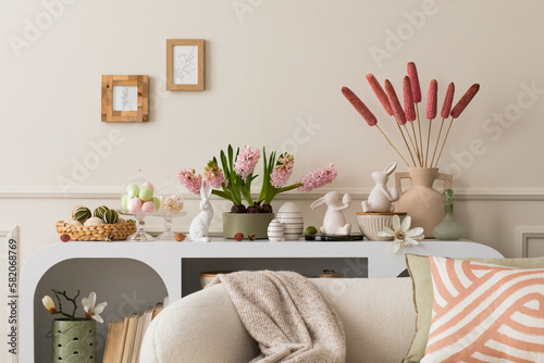 Canvas Print Interior design of easter living room interior with mock up poster frame, stylish white sideboard, hyacinth, easter bunny, vase with dried flowers and personal accessories