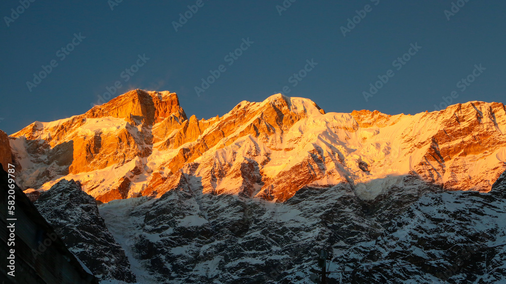 Snow covered mountain shining with the sun rays in Himalaya. The Himalayas are home to some of the most exotic locations in the world, featuring the highest peaks on Earth, snow-clad landscapes,