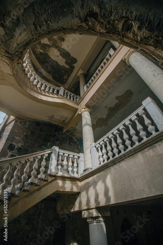 Old vintage decorated spiral staircase in abandoned mansion