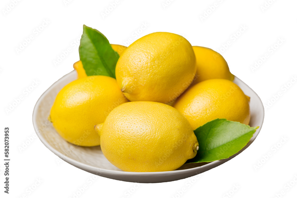 Fresh cutted lemon and whole lemons over round plate isolated on white background. Food and drink ingredients preparing. healthy eating theme top view with copy space