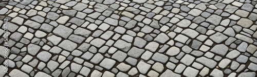 Wide banner illustration of textured stone walkway paved with cobblestones and granite blocks in old urban setting with natural rock shapes. Vector photo