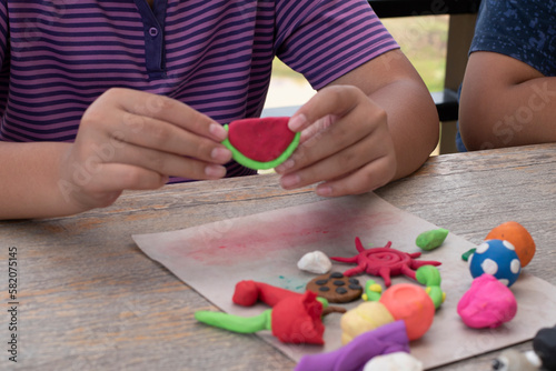 Different shapes and colors of plasticine of the LD children are molded and placed on a table in front of them to train, to concentrate and to increase their brain skills, soft and selective focus.