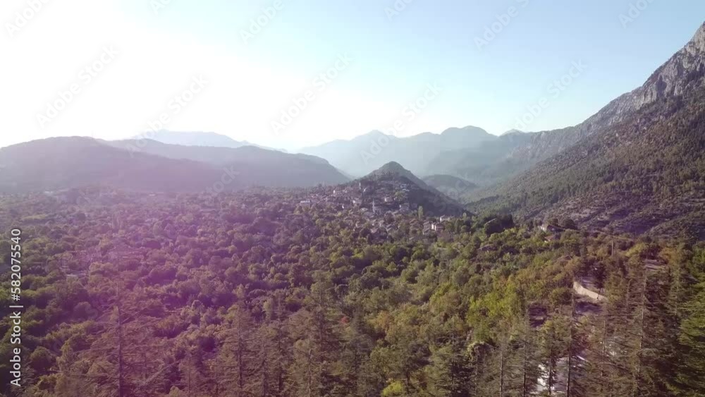The village of Ormana Ibradi exudes a sense of rustic charm, with traditional stone and wood houses nestled among the hills and surrounded by verdant trees. The village of Ormana Ibradi exudes a sense of rustic charm, with traditional stone and wood houses nestled among the hills and surrounded by verdant trees.