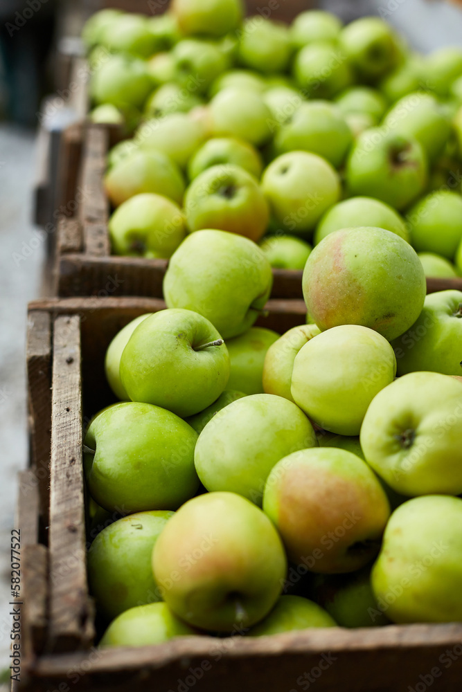 Fresh green apples on the wooden boxes, harvest, space for your text, local market or supermarket, Ukraine apples.