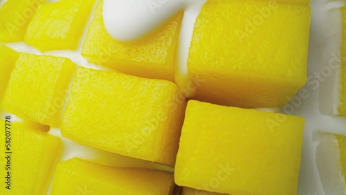 Macro video of mango covered with yoghurt. Shot with RED helium camera in 8K.  