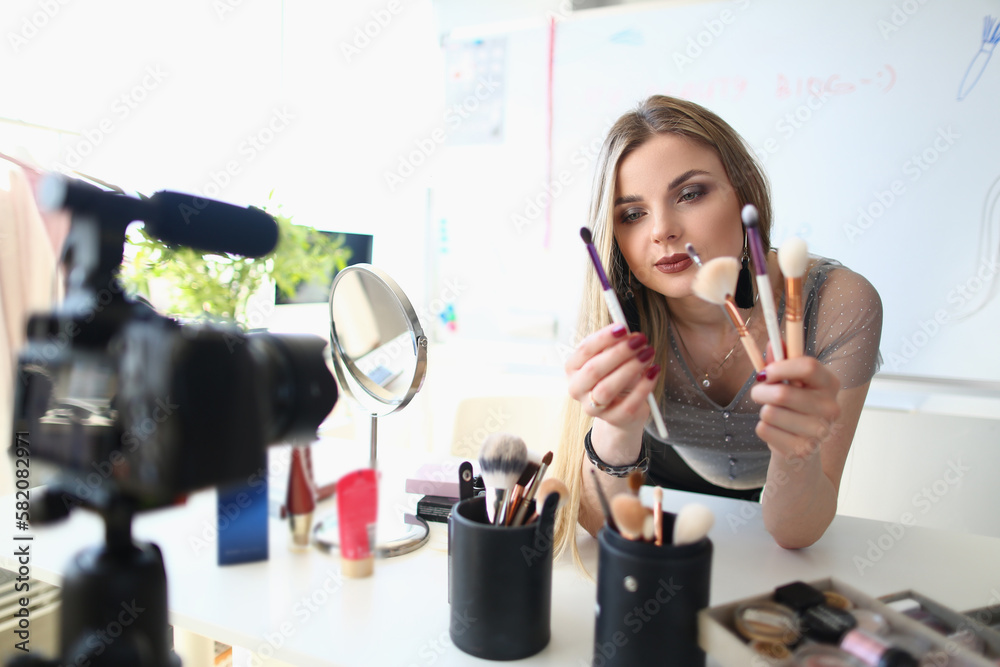 Beauty blogger shoots daily women makeup routine videos on camera Stock ...