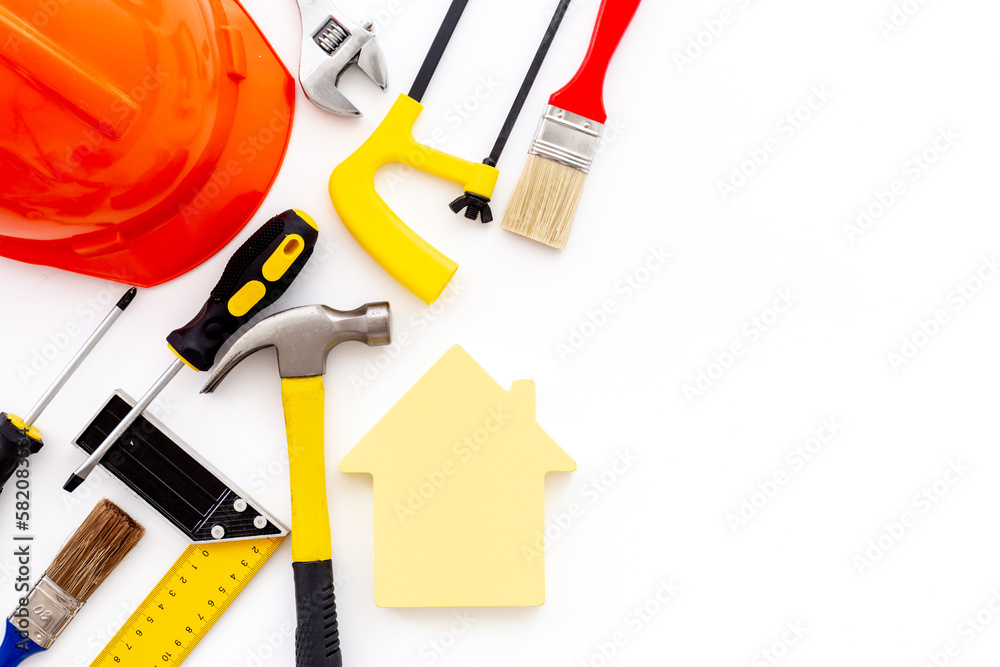Wooden house shape with DIY hand tools and construction tooling Wooden house shape with DIY hand tools and construction tooling
