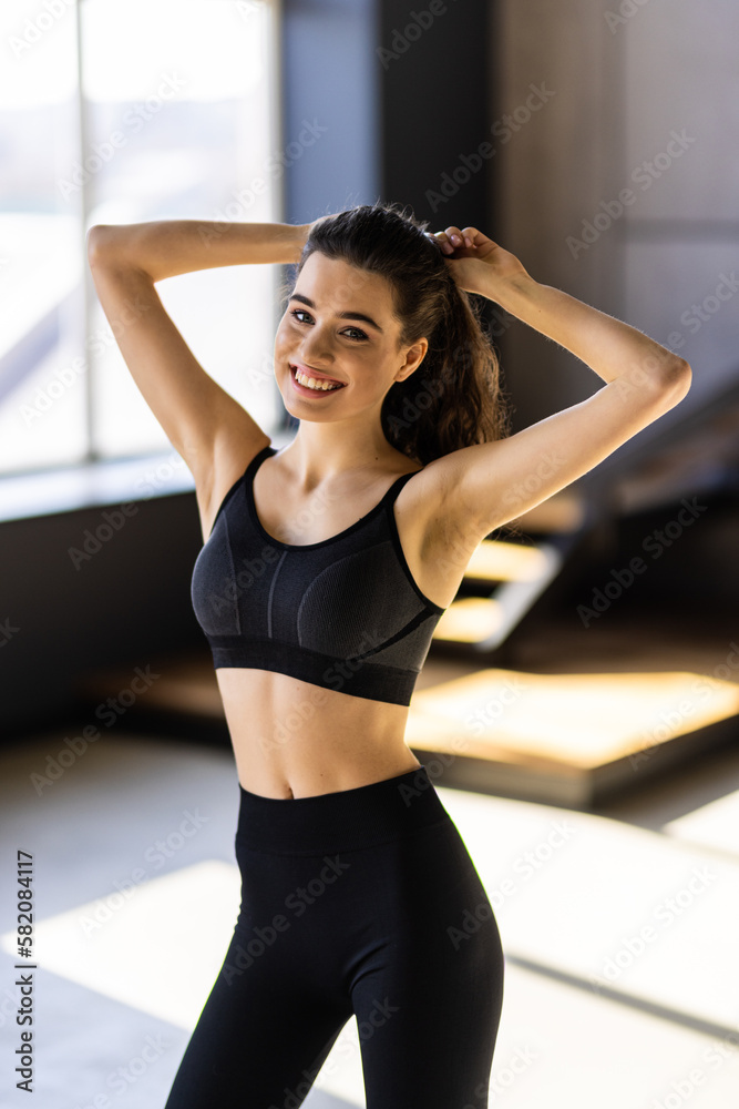 Young attractive woman happy smile rest break sit mat pilates training home Young attractive woman happy smile rest break sit mat pilates training home