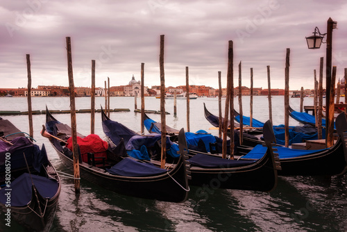 Gondolas in Venice on sunset next to San Marco square. Famous landmark in Italy © Maresol