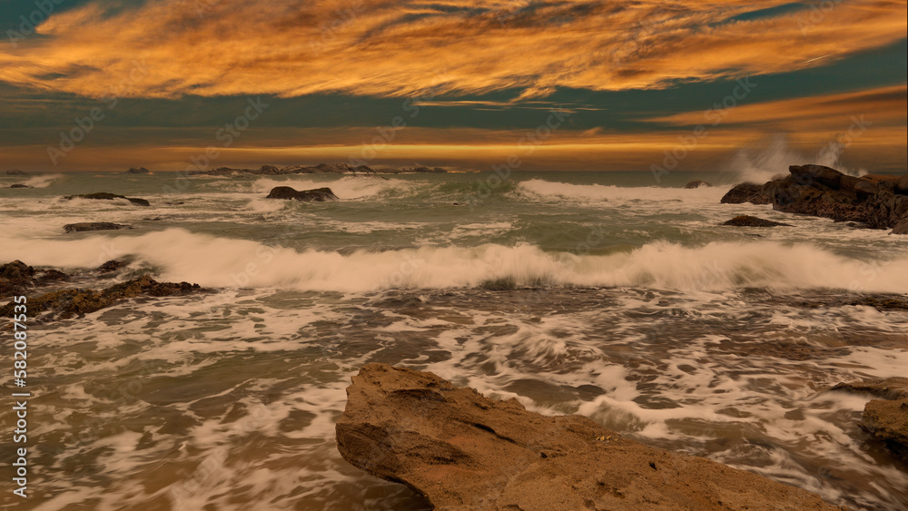 beautiful sunset over the indian ocean with rocks in the foreground sri lanka