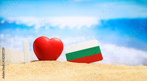 I love Bulgaria. Flag of Bulgaria on the beach with a red heart. vacation and travel concept.