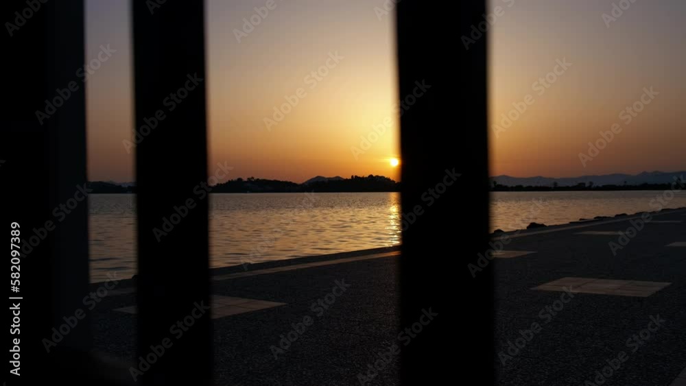 View of a beautiful sea sunset through the railings.