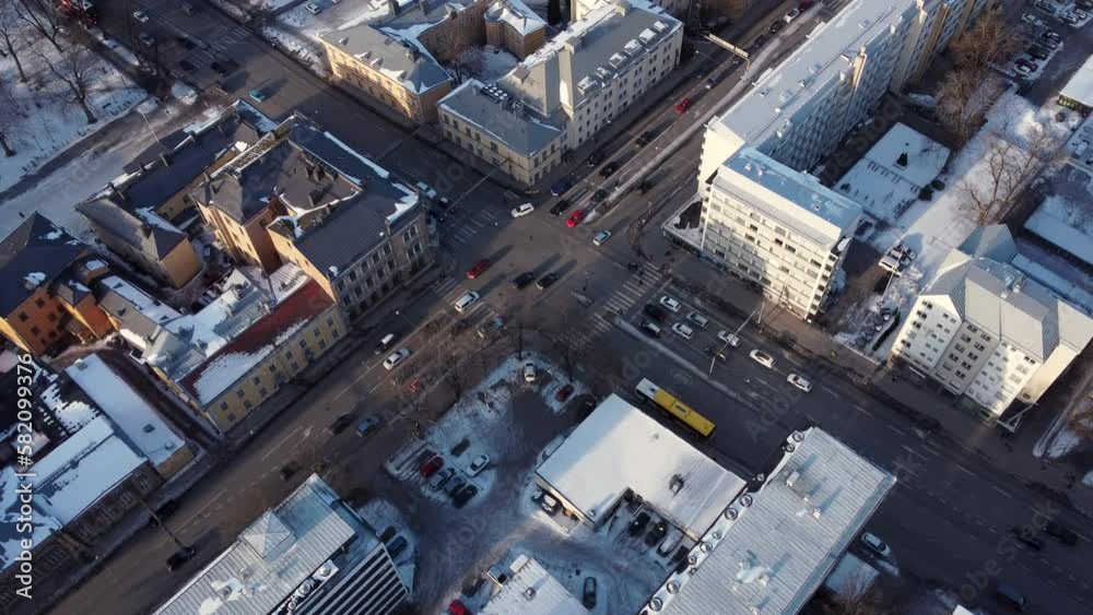 Afternoon traffic in a mid sized intersection near the city center. Dolly forward drone shot Afternoon traffic in a mid sized intersection near the city center. Dolly forward drone shot