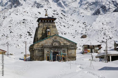 Kedarnath temple, shrine covered with snow. Kedarnath temple is a Hindu temple dedicated to Shiva. Located on the Garhwal Himalayan range near the Mandakini river. photo