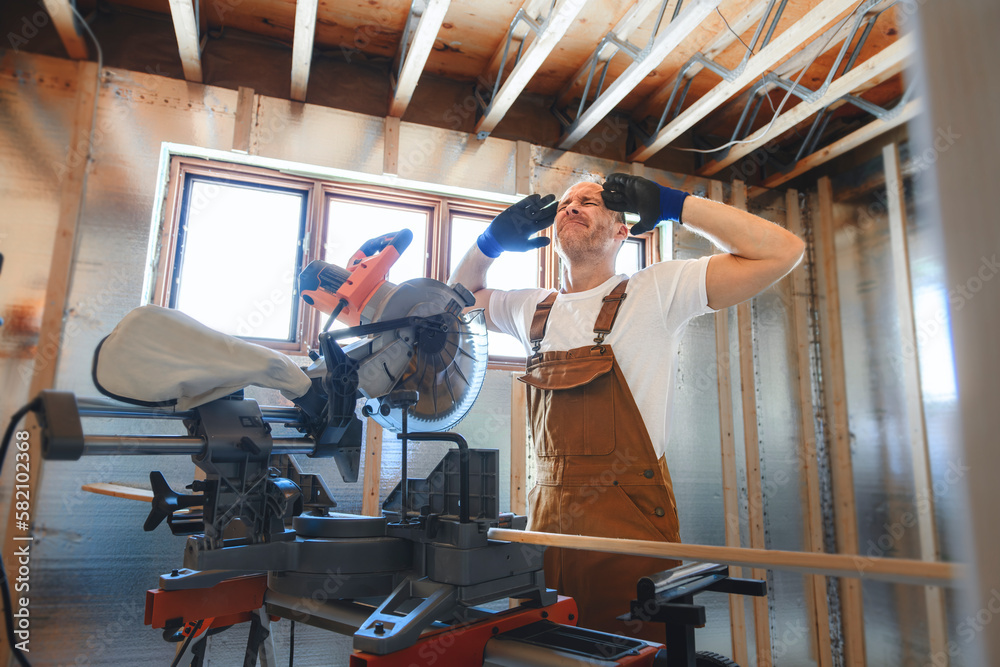 Construction Worker Using Power Tool in Unfinished Basement of New Home Stock Photo Adobe Stock