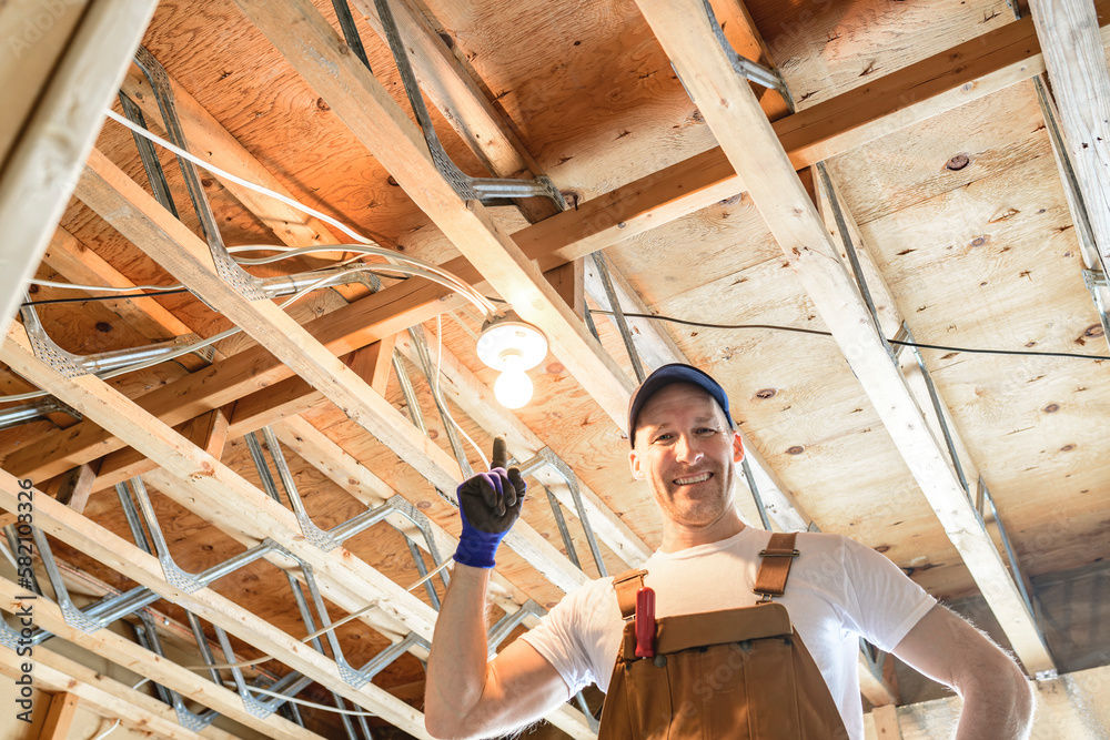 An Electrician Male Working on basement bulb