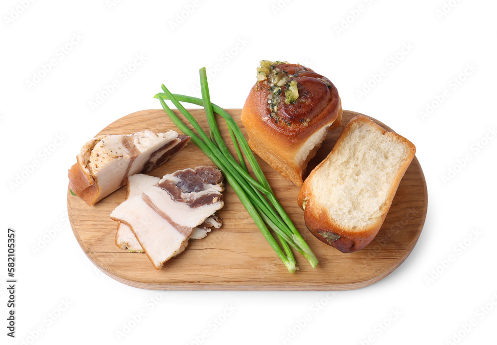 Board with delicious pampushky (buns), salo and green onions isolated on white