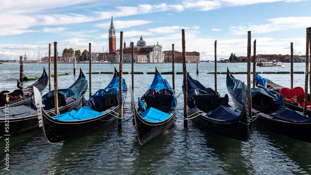 San Giorgio Maggiore is a stunning church located on an island in Venice's lagoon. The church's iconic white facade and towering bell tower provide a striking contrast against blue sky and water.