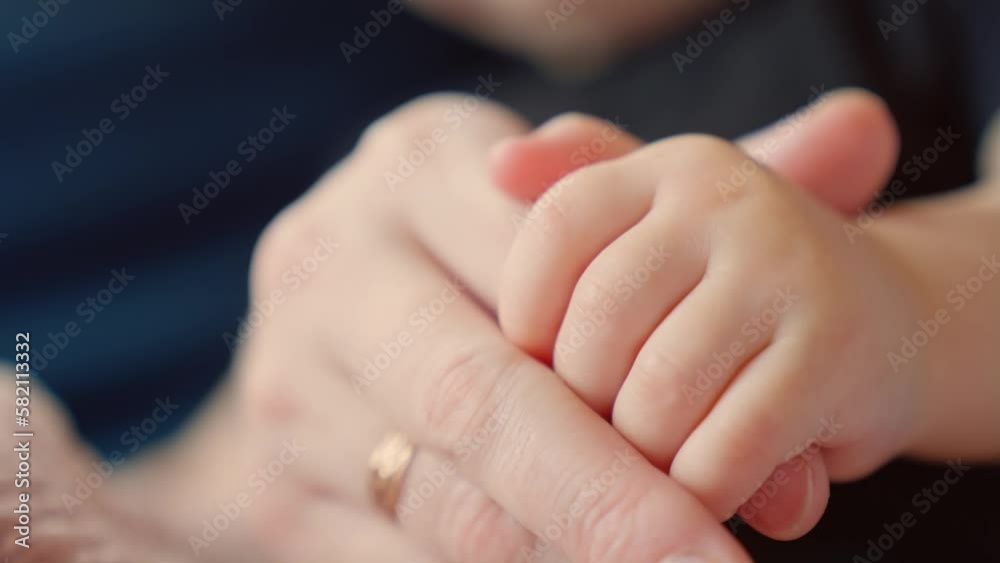 mother holds the hand of a newborn. children hand. hospital takes care of happy family medicine concept. newborn baby holding mom hand close-up. mom takes care dream baby in the hospital mother holds the hand of a newborn. children hand. hospital takes care of happy family medicine concept. newborn baby holding mom hand close-up. mom takes care dream baby in the hospital